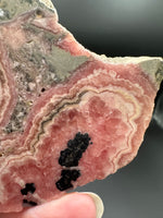 Natural Rhodochrosite Slab #17 – Pink Banded Mineral Specimen with Black Matrix