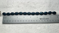 Czech Glass Peacock Eye Oval Bead Strand – Black & Iridescent Blue –