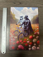 Vader & Storm Trooper Riding in a Field of Flowers Framed Canvas Print